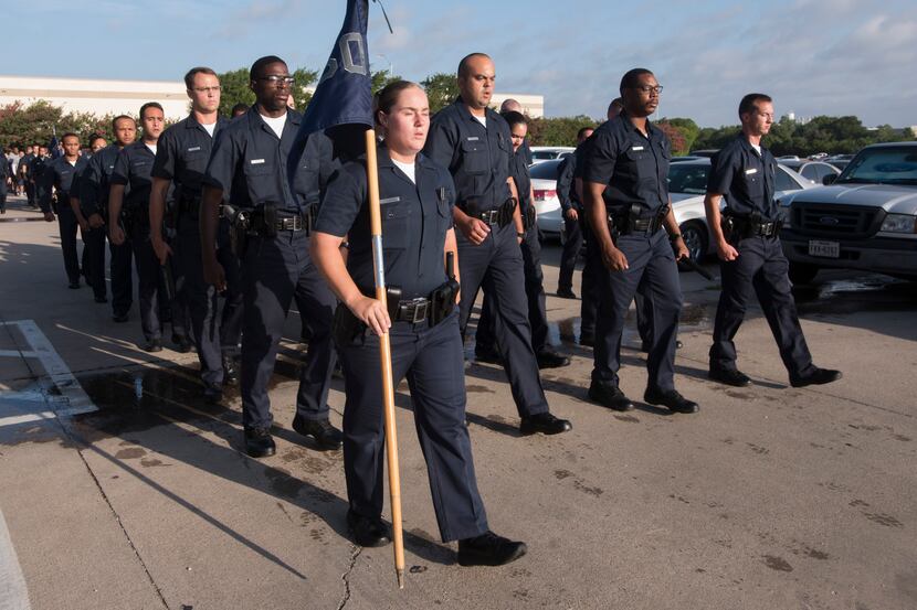 Dallas Police Department recruits march through morning formation at the Dallas Police...