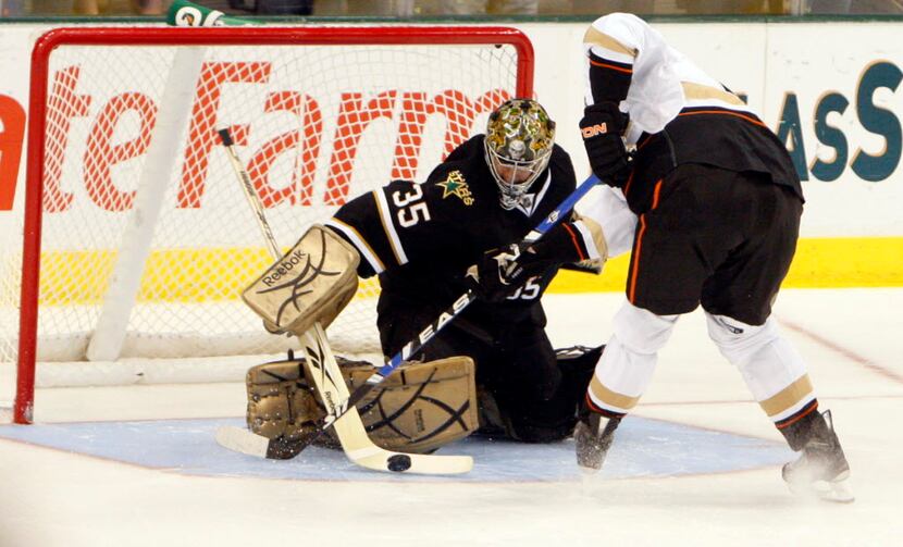 Dallas Stars Marty Turco (35) stops a shot from Anaheim Ducks Corey Perry (10) during the...