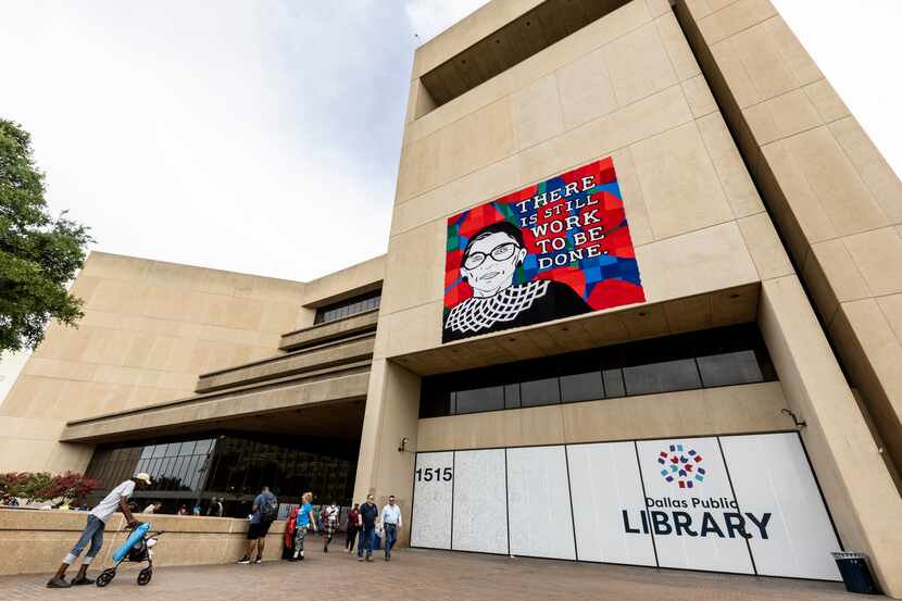 A Crochet portrait of Ruth Bader Ginsburg hangs on the front of the Dallas Public Library's...