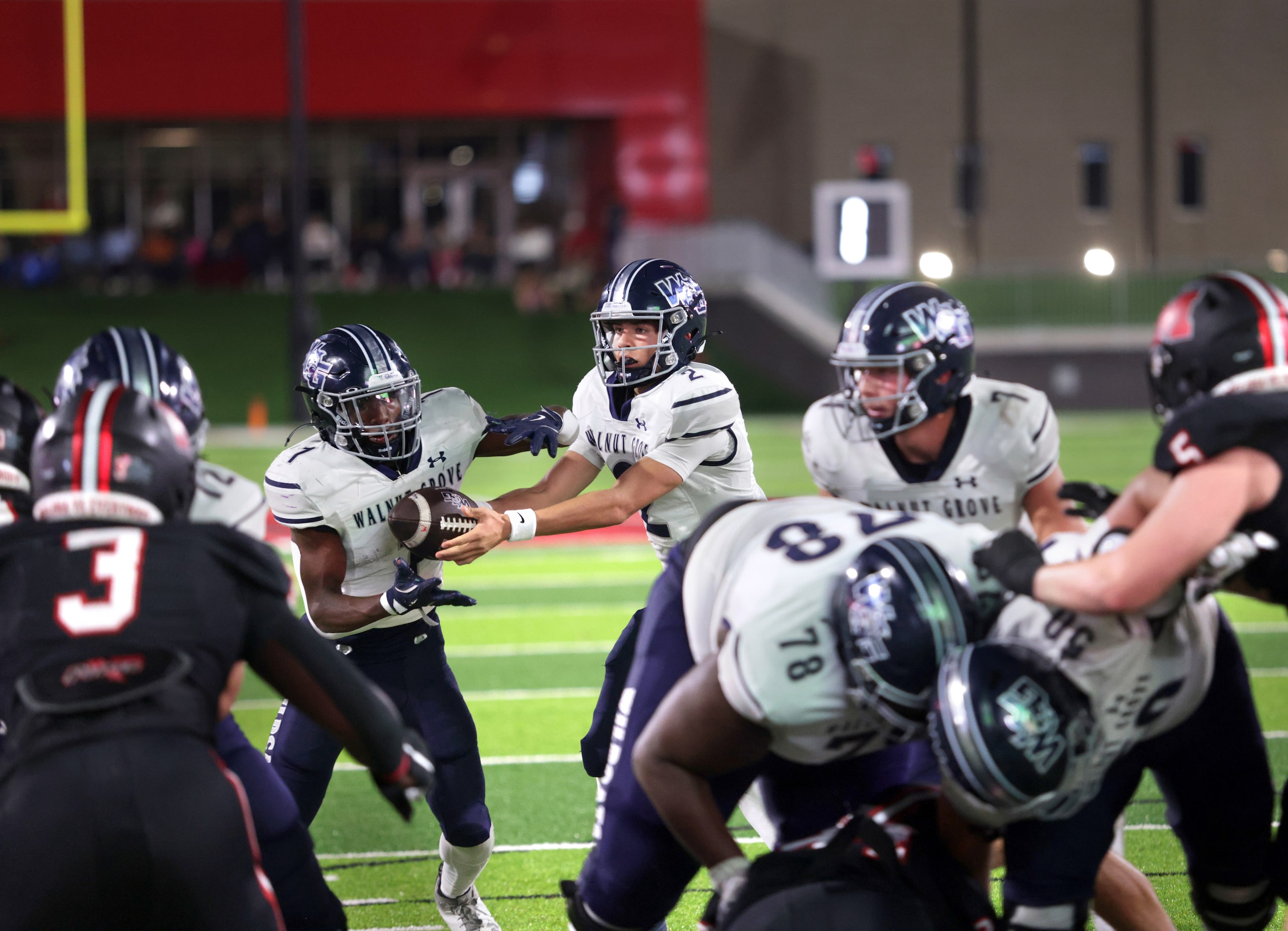 Walnut Grove player #2 Hayes Hackney hands off to player #1 Cam Newton during the Prosper...