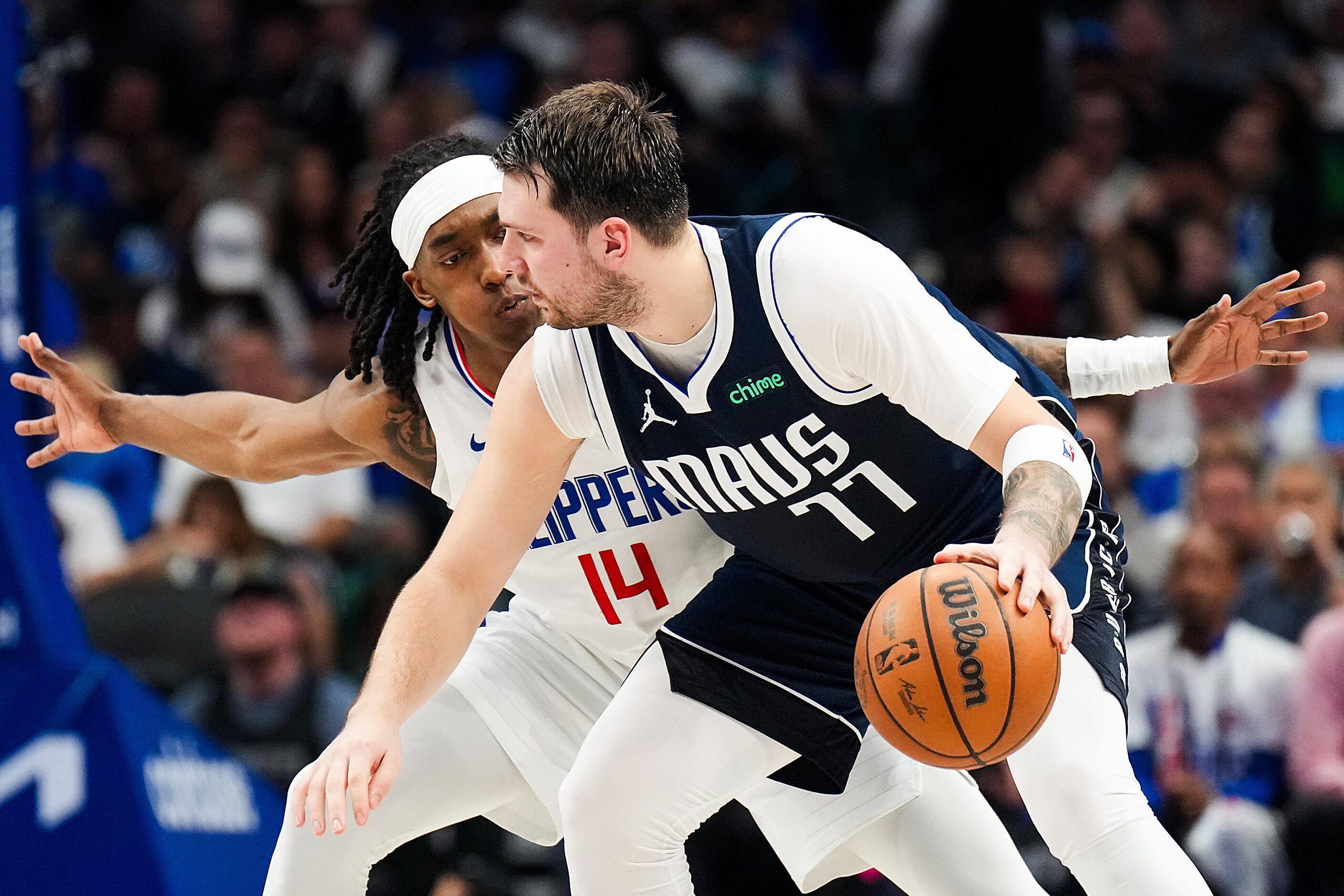 Dallas Mavericks guard Luka Doncic (77) is defended by LA Clippers guard Terance Mann (14)...