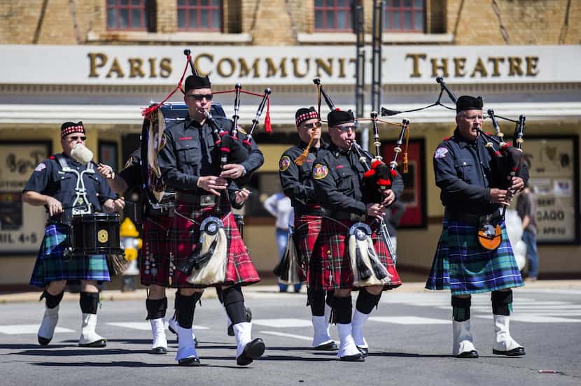 
The Plano Fire Department and Bagpipe Corps led firetrucks down First Street during...