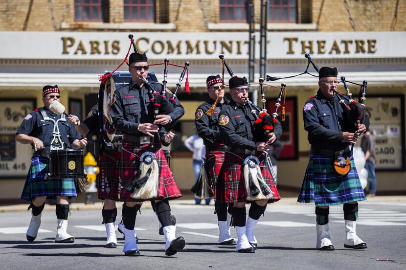 
The Plano Fire Department and Bagpipe Corps led firetrucks down First Street during...