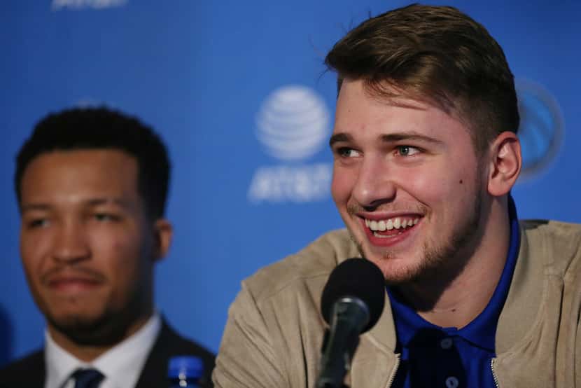 Dallas Mavericks player Luka Doncic speaks while he is introduced with Jalen Brunson (left)...