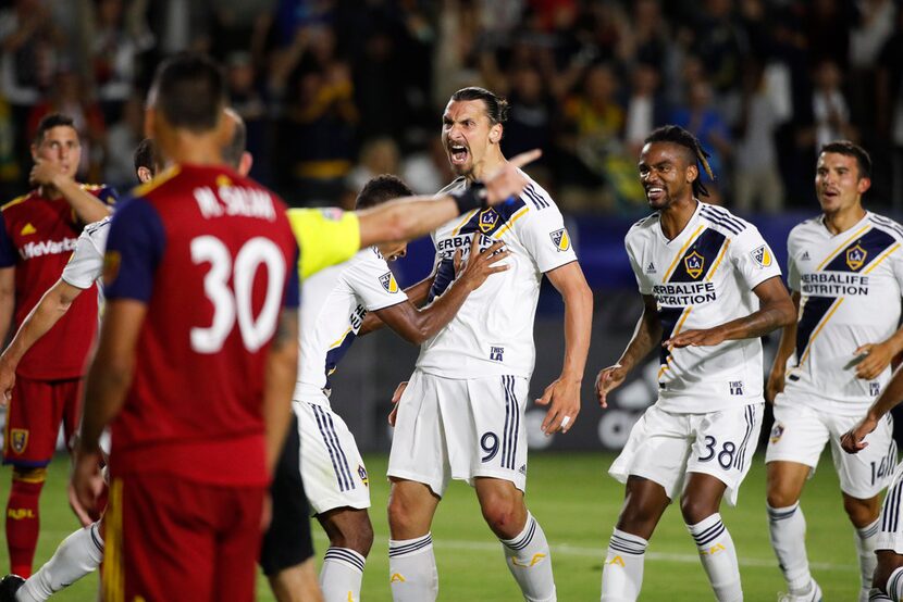 LA Galaxy's Zlatan Ibrahimovic, center, of Sweden, celebrates his goal with teammates during...