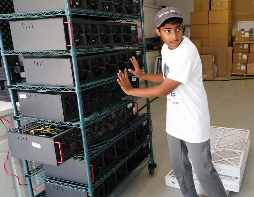 Frisco resident Ishaan Thakur, 14, expains how he is mining cryptocurrency with computers in...