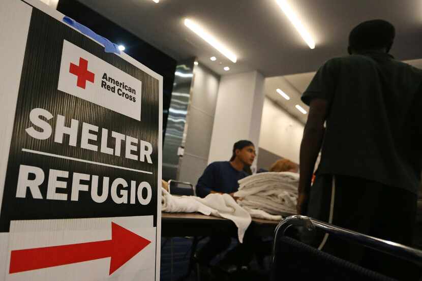 Signs show the way for the Red Cross shelter at the George R. Brown Convention Center in ...