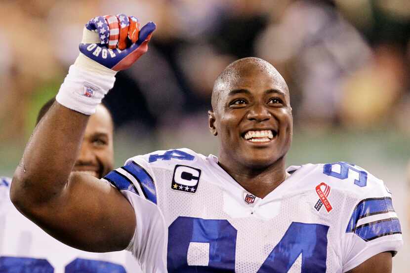 Dallas Cowboys outside linebacker DeMarcus Ware celebrates a touchdown by teammate Miles...