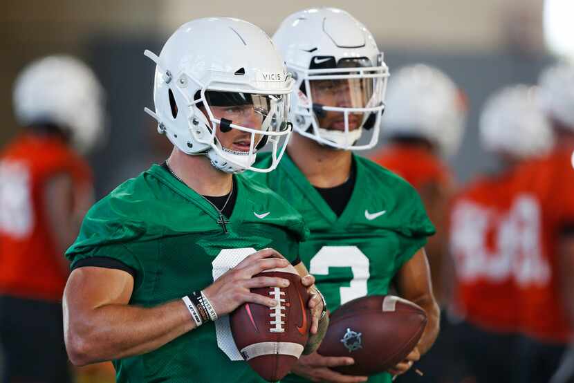 Oklahoma State quarterbacks Dru Brown, left, and Spencer Sanders, right, listen to...