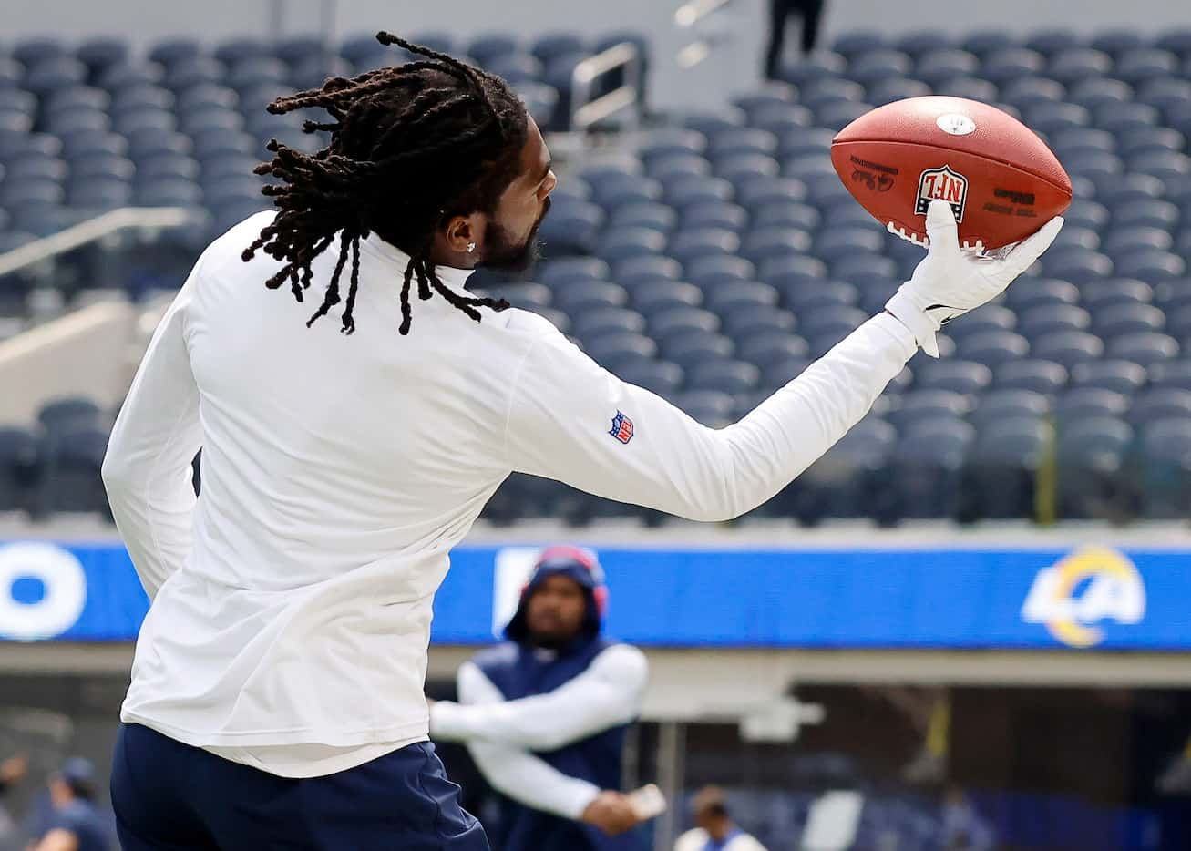 Dallas Cowboys cornerback Trevon Diggs catches a pass as he warms up before the Los Angeles...