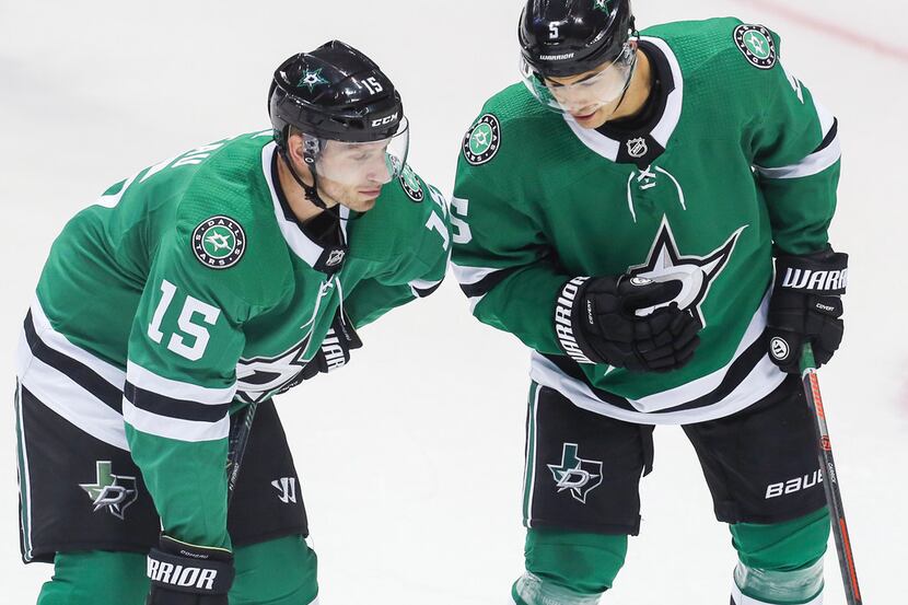 Dallas Stars defenseman Connor Carrick (5) talks to left wing Blake Comeau (15) during the...