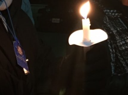  A man wearing a whistle with a card remembering George Moss as "Coach George Moss" stands...