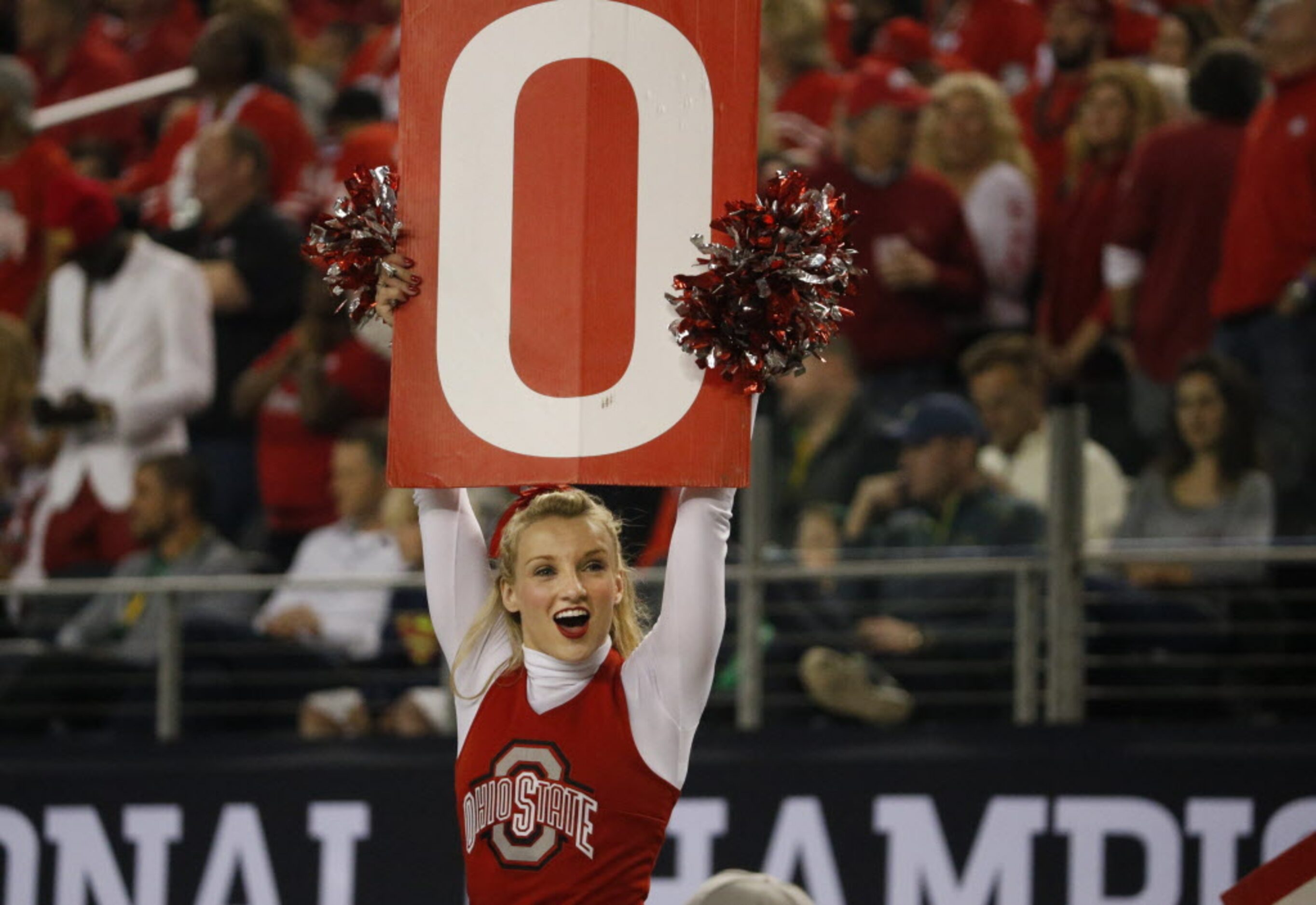 An Ohio State cheerleader leads the crowd during the first half of the College Football...