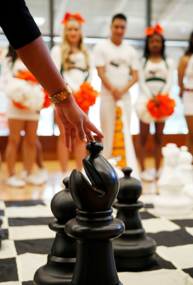 Student Deepthi Savulgay plays larger-than-life chess during a campus pep rally for the...