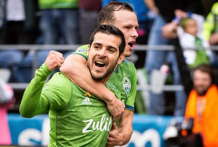 Seattle Sounders midfielder Victor Rodriguez, left, and defender Brad Smith celebrate after...