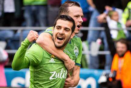 Seattle Sounders midfielder Victor Rodriguez, left, and defender Brad Smith celebrate after...