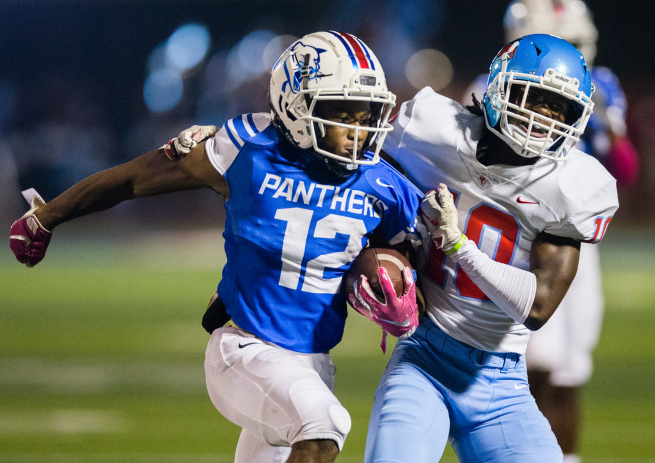 Duncanville running back Suavevion Persley (12) is pushed out of bounds by Skyline defensive...