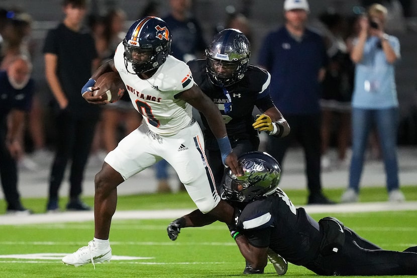 Sachse running back Brendon Haygood (0) is tripped up by Wylie East linebacker Sean Berry...