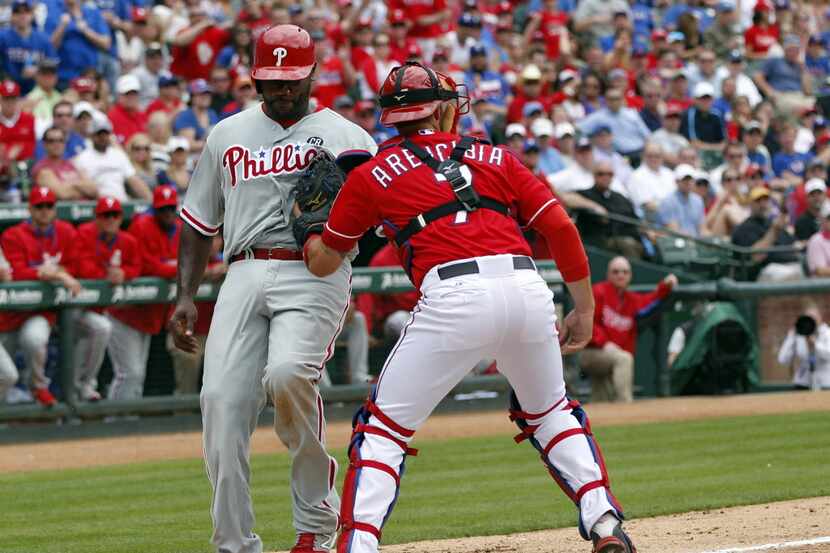 Philadelphia Phillies first baseman Ryan Howard (6) is tagged out at home by Texas Rangers...