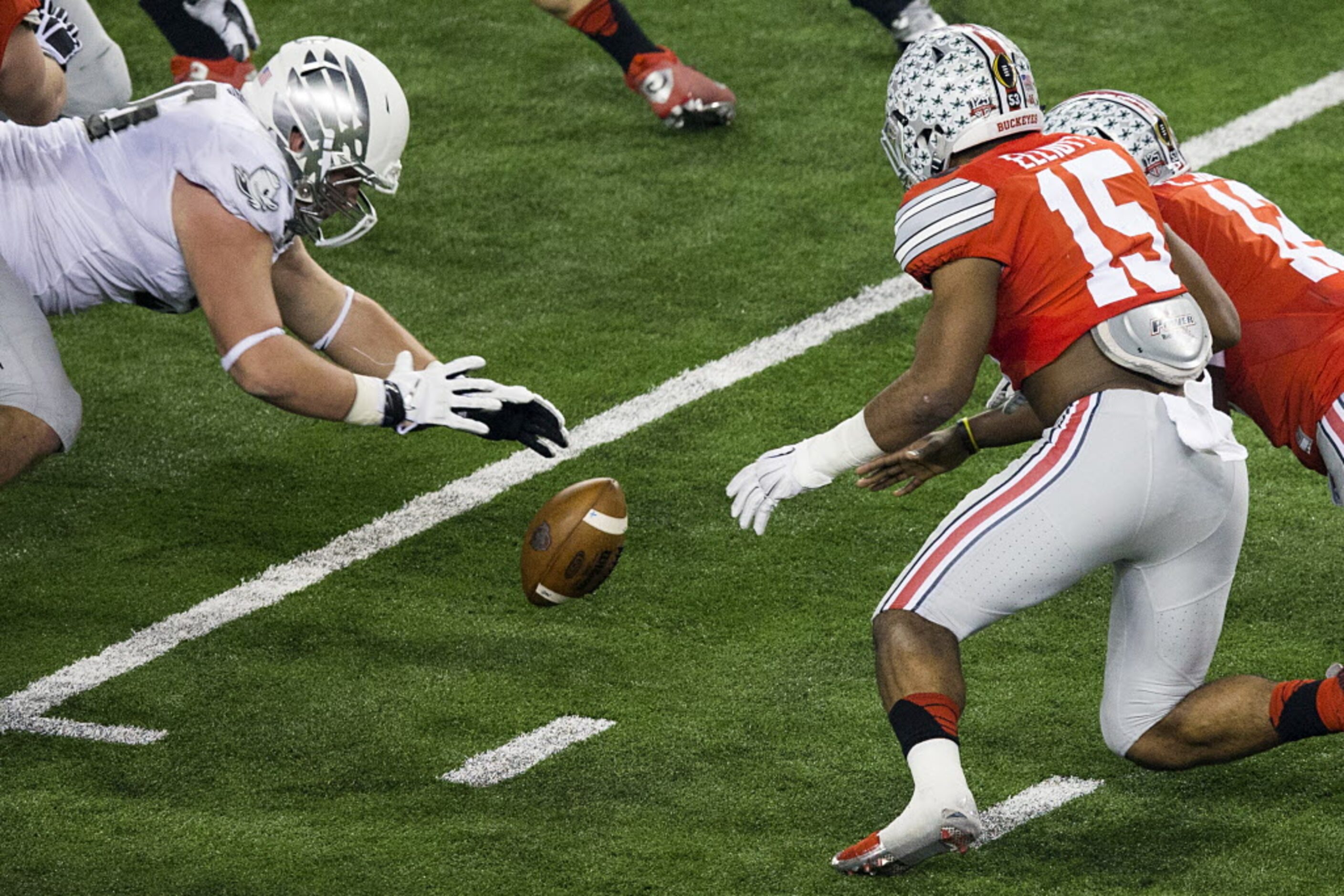 Oregon Ducks defensive lineman Alex Balducci (56) recovers a fumbled handoff between Ohio...