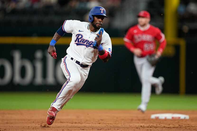 Texas Rangers' J.P. Martinez sprints home to score on a Leody Taveras double in the eighth...