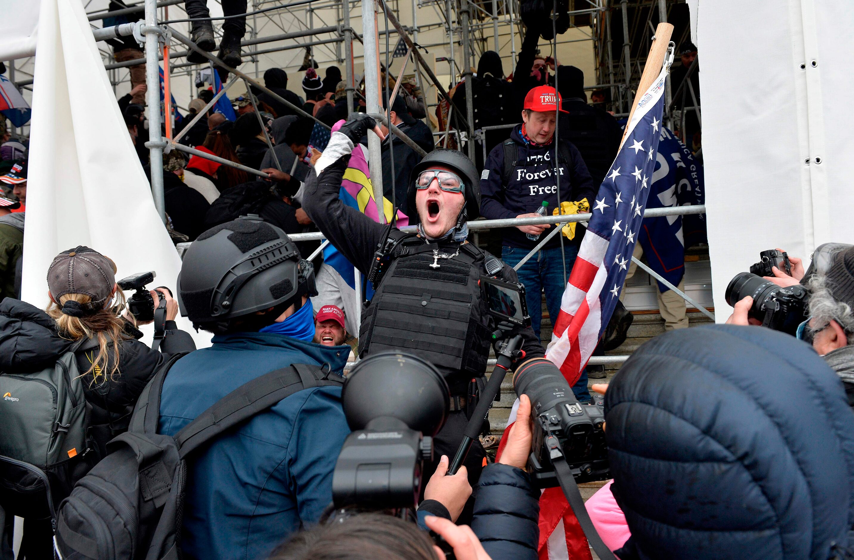 A man calls on people to raid the building as Trump supporters clash with police and...