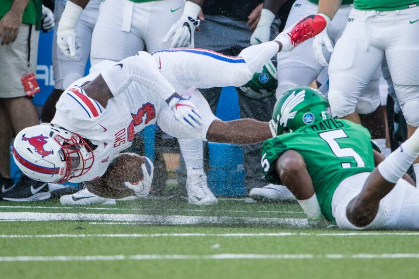 Southern Methodist Mustangs wide receiver James Proche (3) is brought down by North Texas...