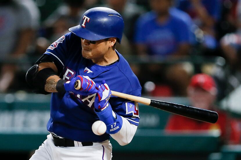 Texas Rangers' Shin-Soo Choo  is hit by a pitch on his left arm during the 12th inning of...