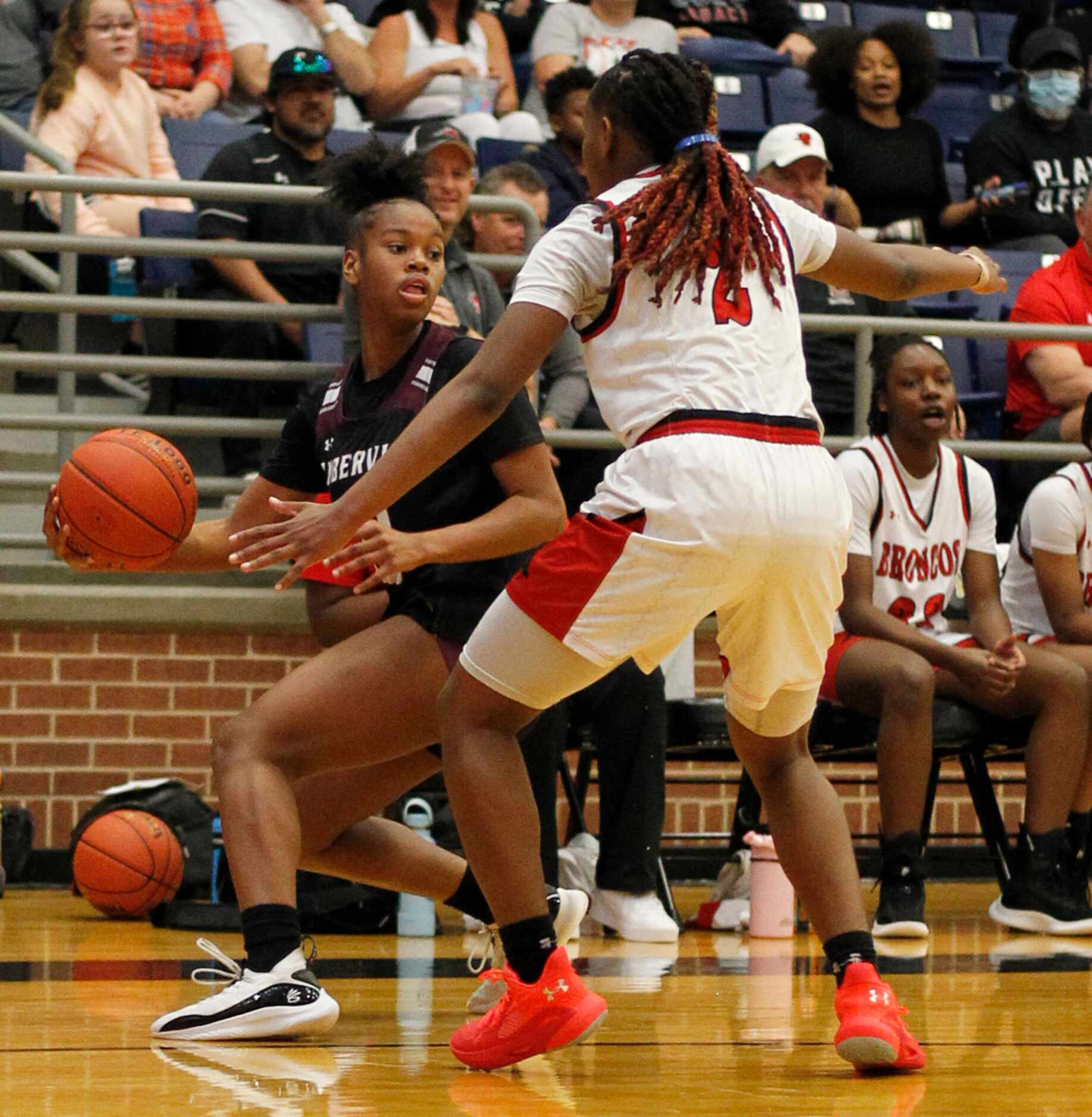 Mansfield Timberview guard Kamryn Wilson (10), left, looks to pass as she is defended by...