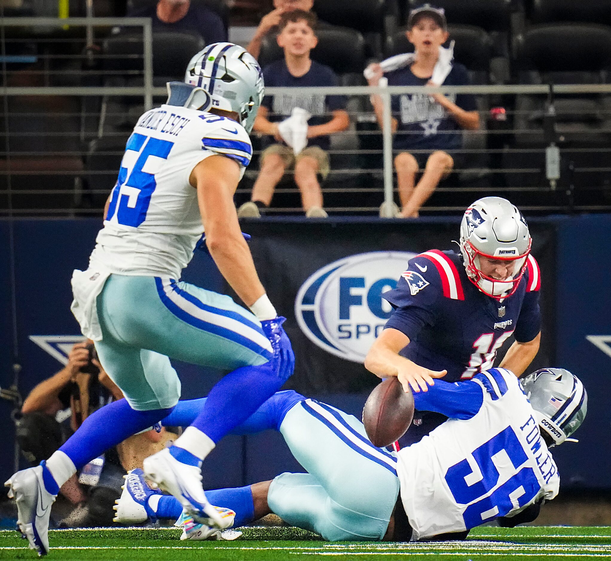 New England Patriots quarterback Mac Jones (10) fumbles as he is hit by Dallas Cowboys...