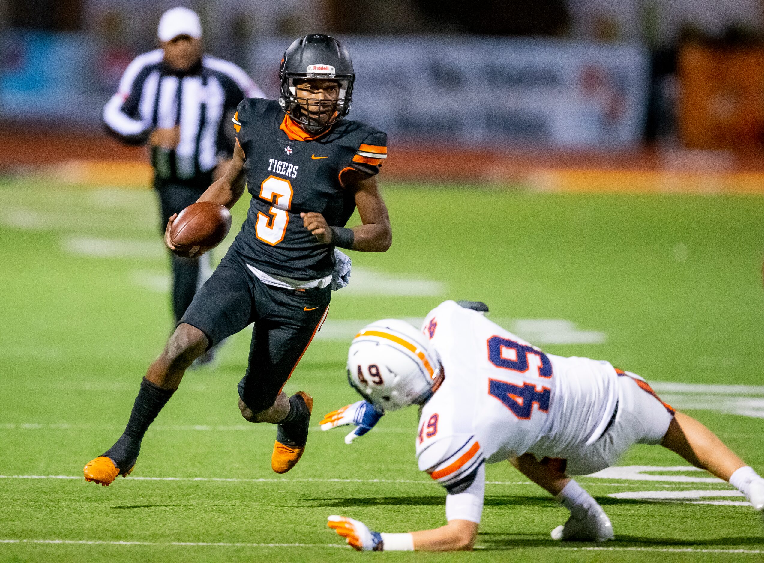 Lancaster junior quarterback Glenn Rice Jr. (3) avoids Wakeland sophomore outside linebacker...