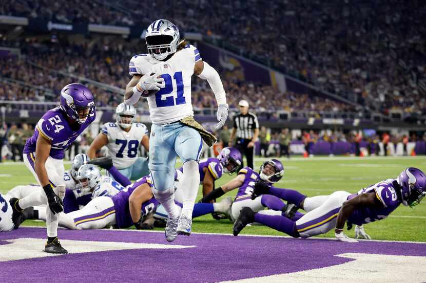 Dallas Cowboys running back Ezekiel Elliott (21) bounced off of Minnesota Vikings lineman...