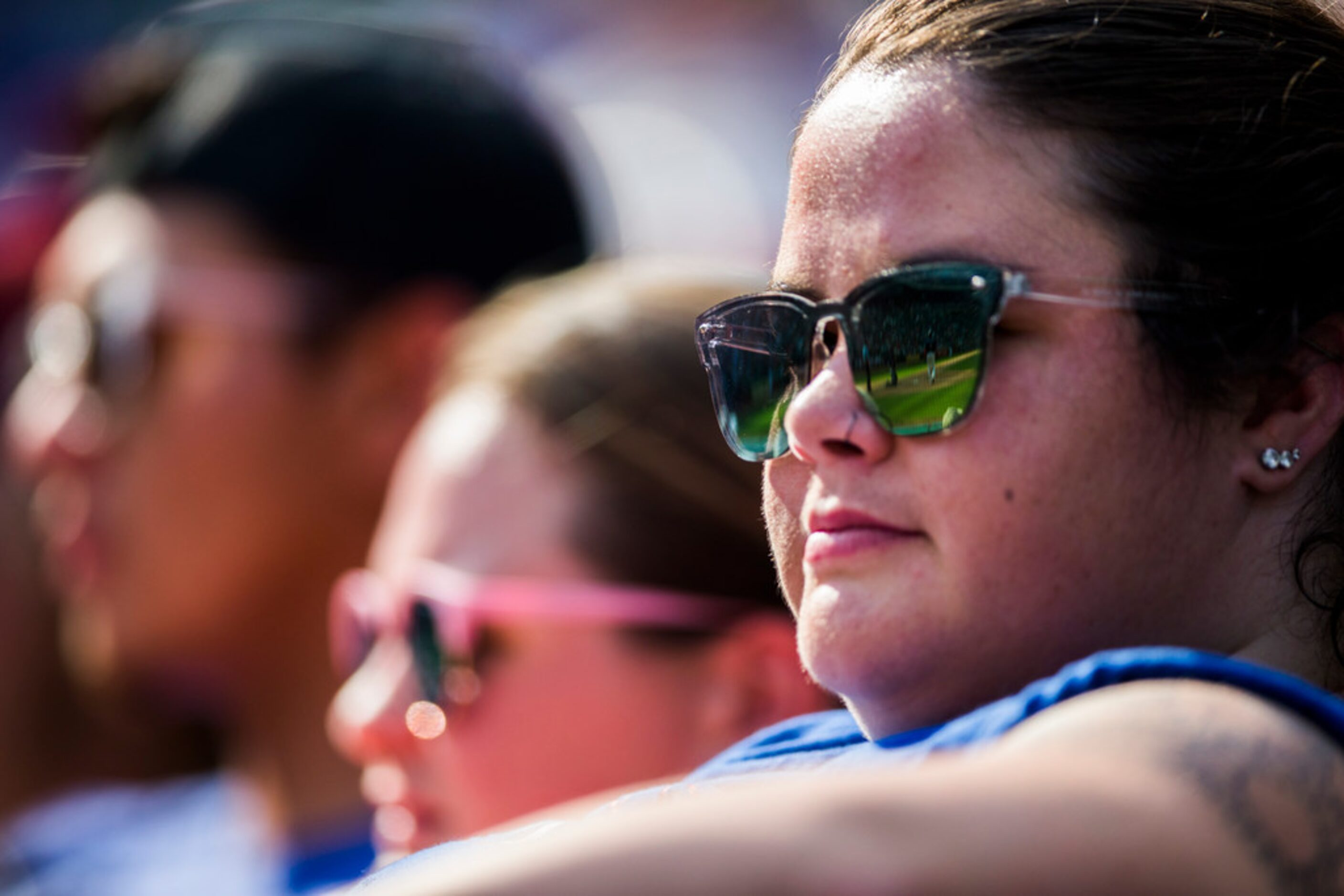 Texas Rangers fans watch the game through sunglasses during the seventh inning of an MLB...