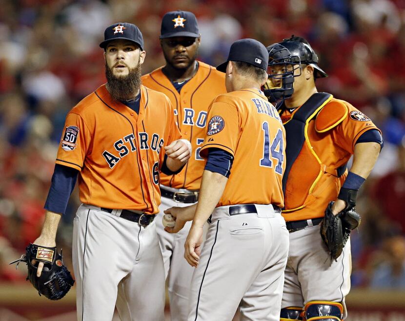 Houston Astros starting pitcher Dallas Keuchel (left) is pulled out of the game by manager...