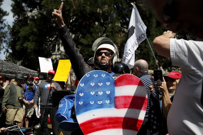 BERKELEY, CA - APRIL 27:  A right wing activist holds a shield in the shape of a heart...
