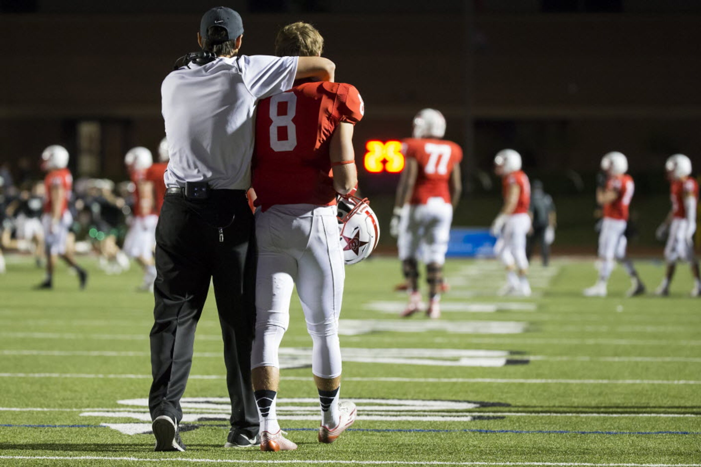 Coppell wide receiver Josh Fink (8) is consoled by a coach following an overtime loss to...