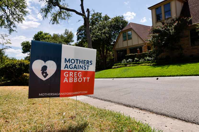 A Mothers against Greg Abbott political action committee sign in a yard in Old East Dallas...