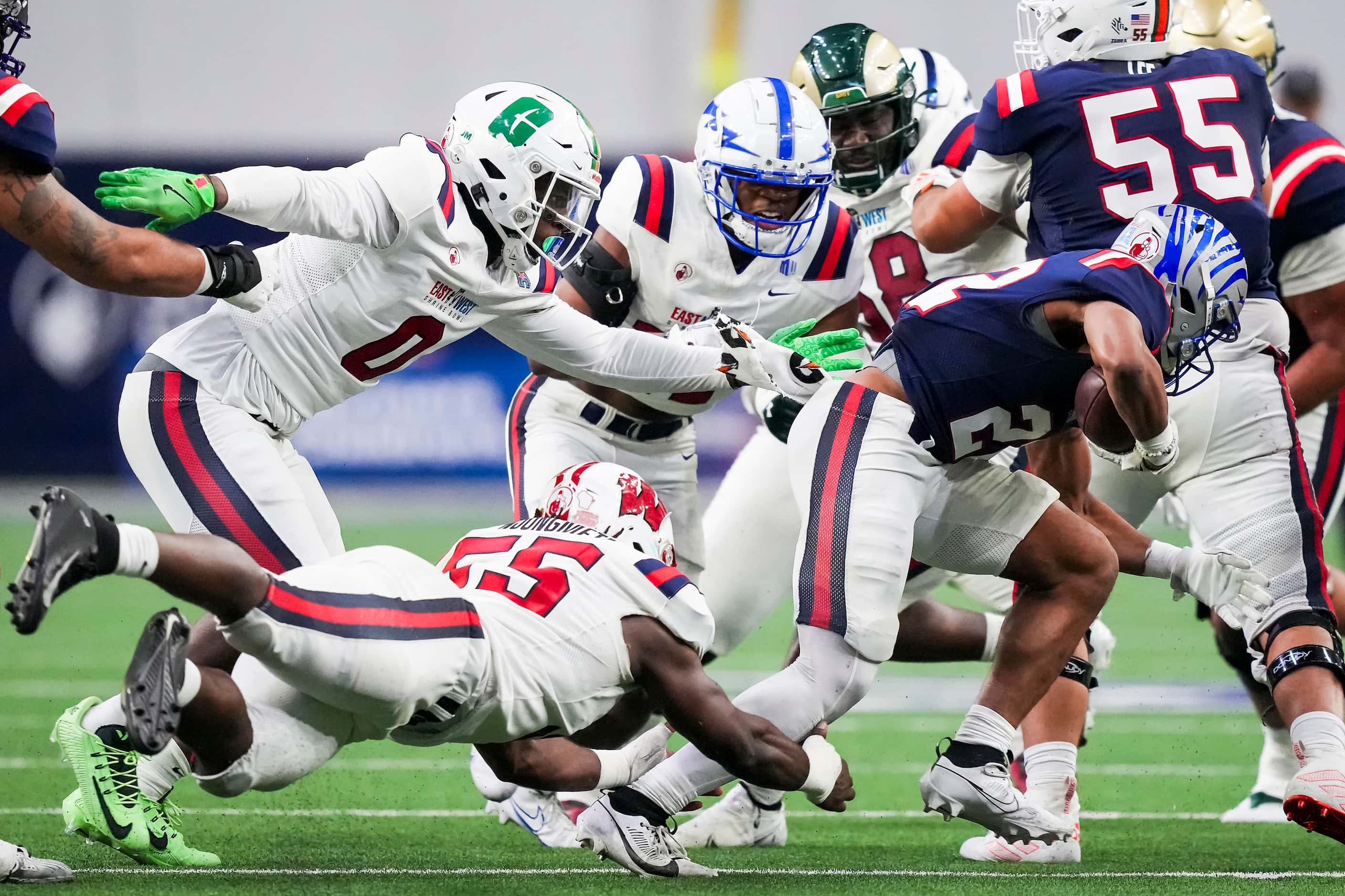 West runninbg back Blake Watson of Memphis  (22)  is brought down by East linebacker Maema...