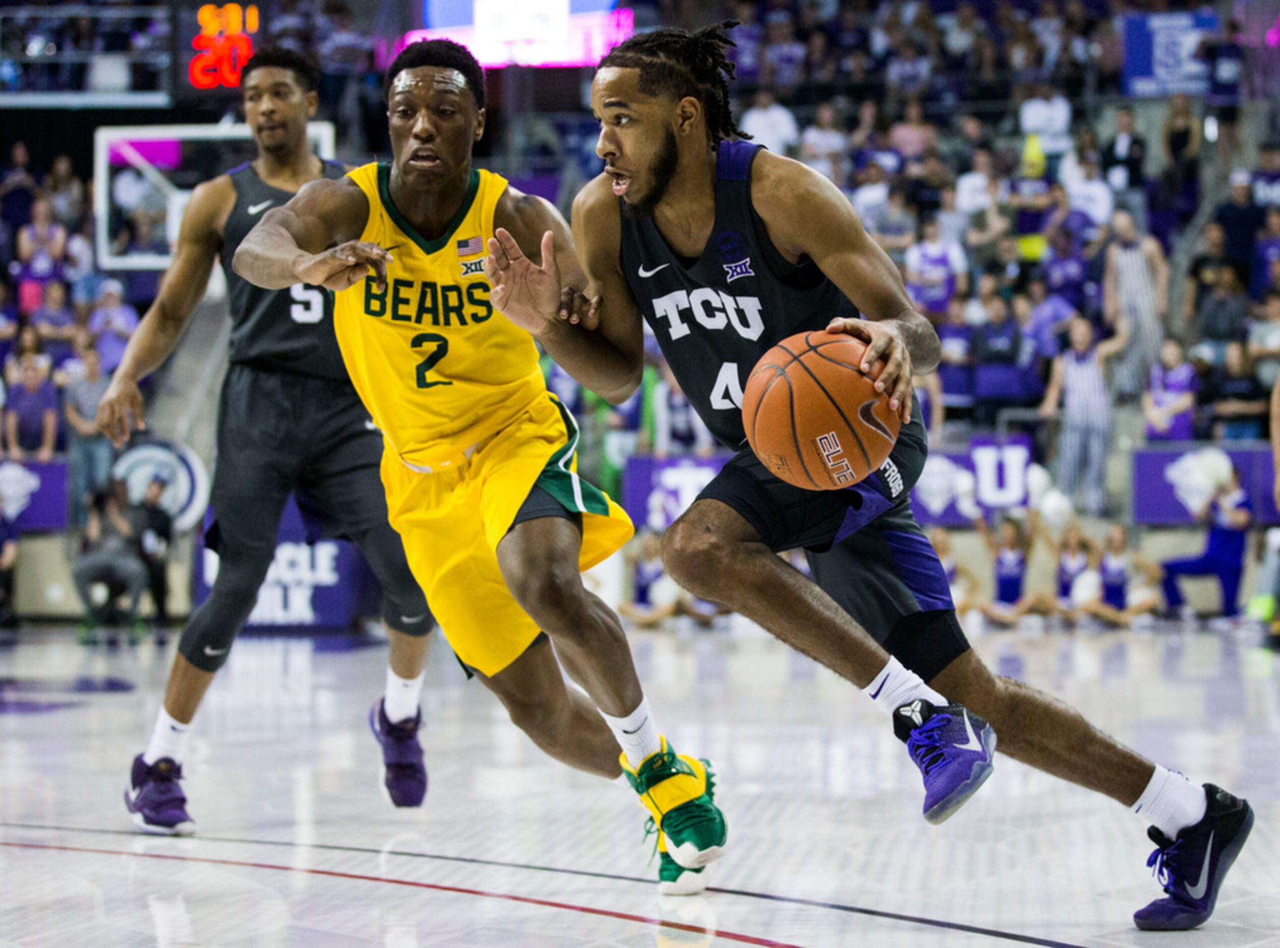 TCU Horned Frogs guard PJ Fuller (4) gets around Baylor Bears guard Devonte Bandoo (2)...