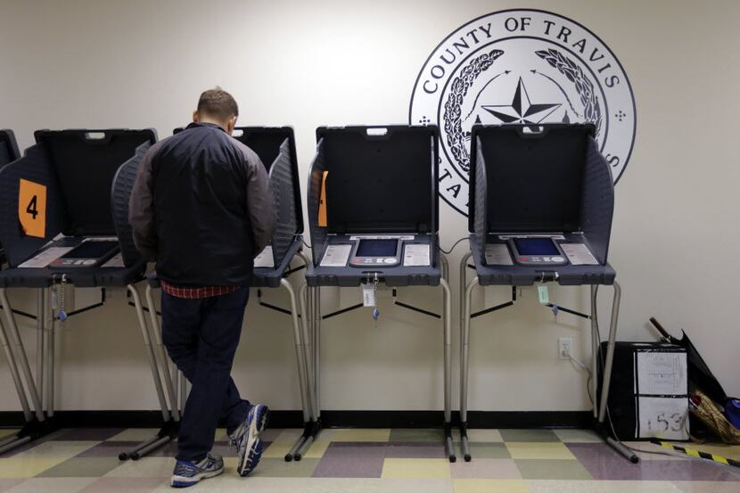 A voter casts his ballot at an early voting polling site in Austin, Texas in 2014. (AP...