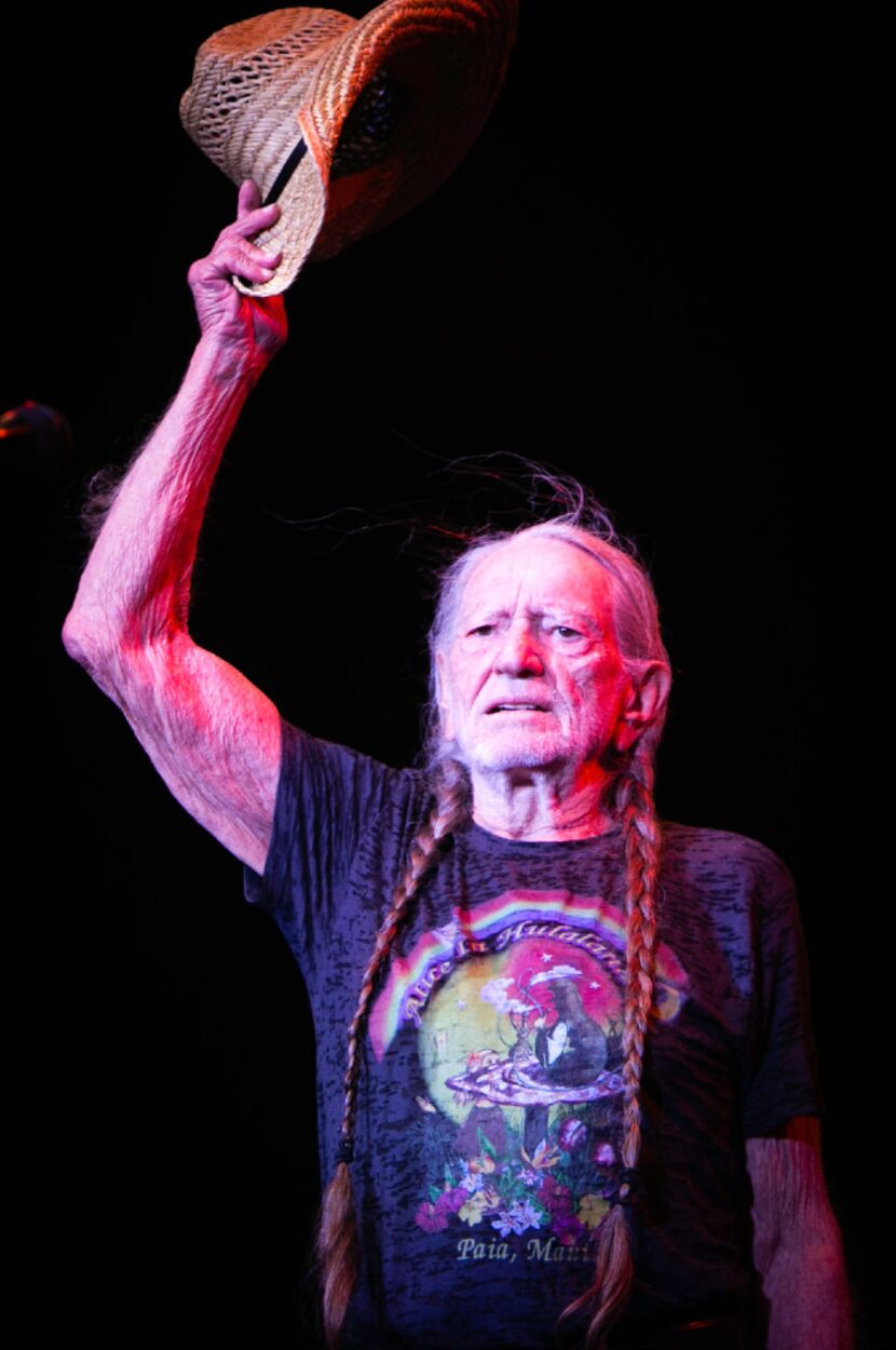 Willie Nelson greets the crowd during the Outlaw Music Festival at the Starplex Pavilion in...