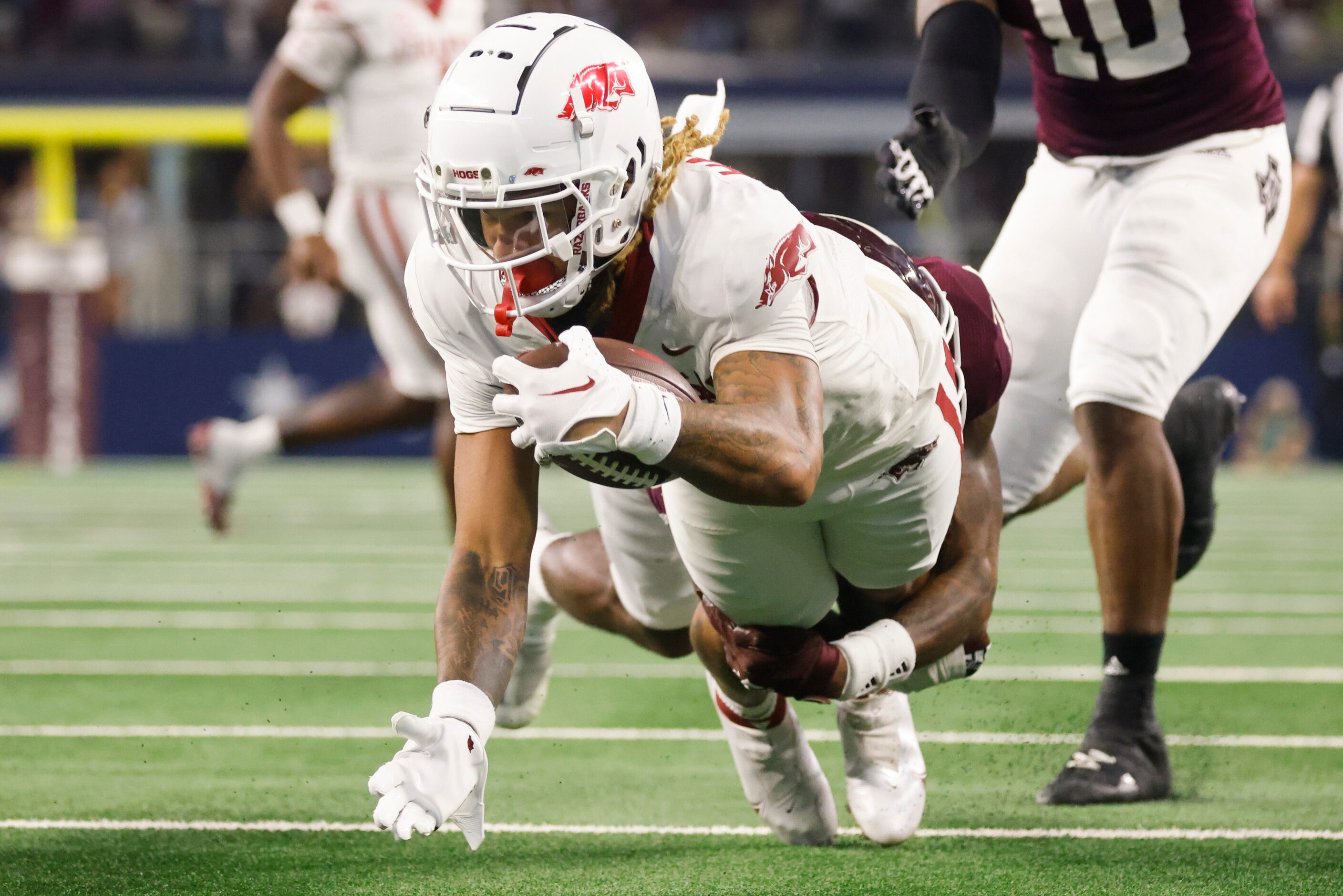 Arkansas wide receiver Jadon Haselwood gets tackled while running a yardage by...