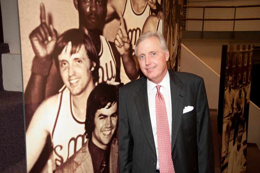 David Miller stands in front of a photo from his days as a starting center for SMU.