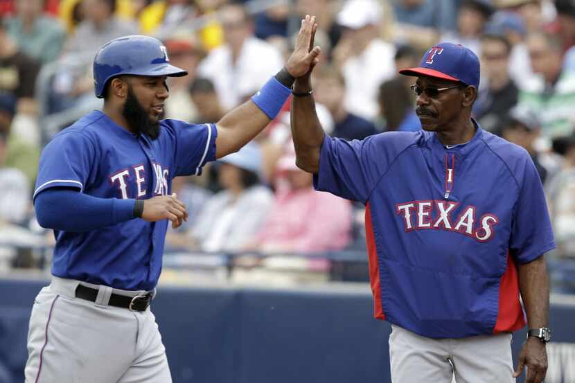 Texas Rangers' Elvis Andrus is congratulated by manager Ron Washington after Andrus scored...