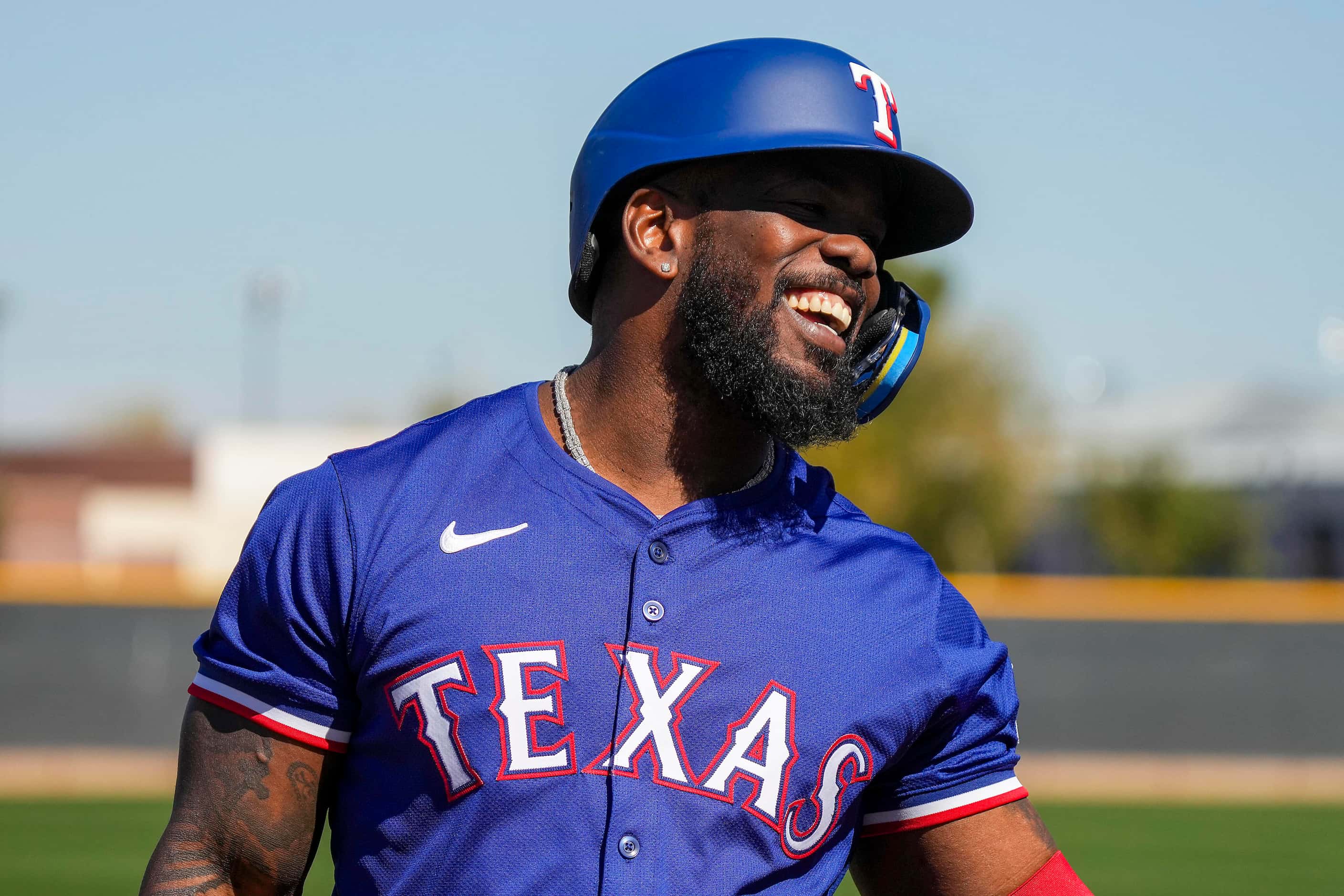 Texas Rangers outfielder Adolis García laughs with teammates while waiting to hit live...