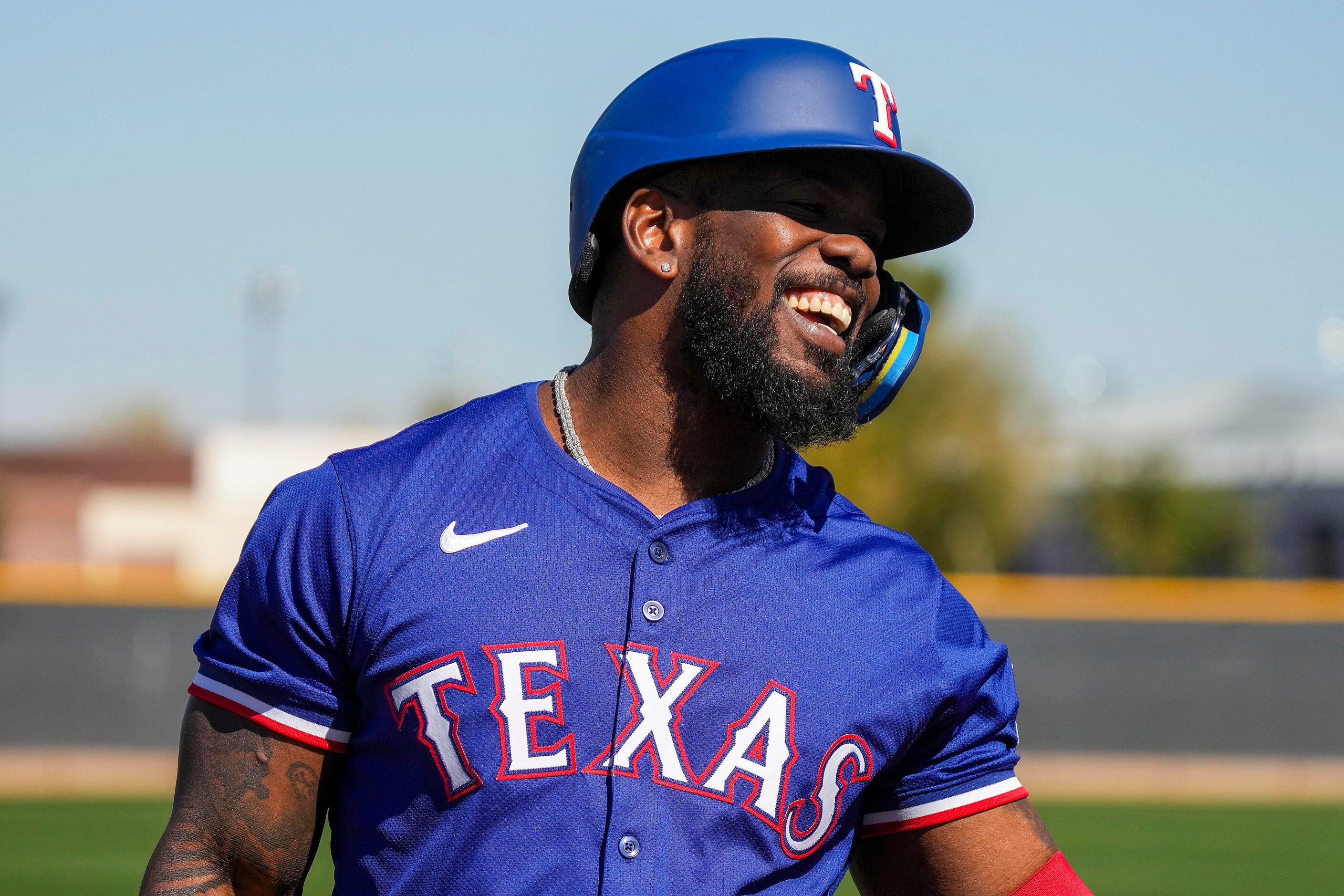 Texas Rangers outfielder Adolis García laughs with teammates while waiting to hit live...