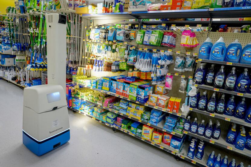 A robotic shelf scanner moves along an aisle at a North Richland Hills Walmart on April 5,...