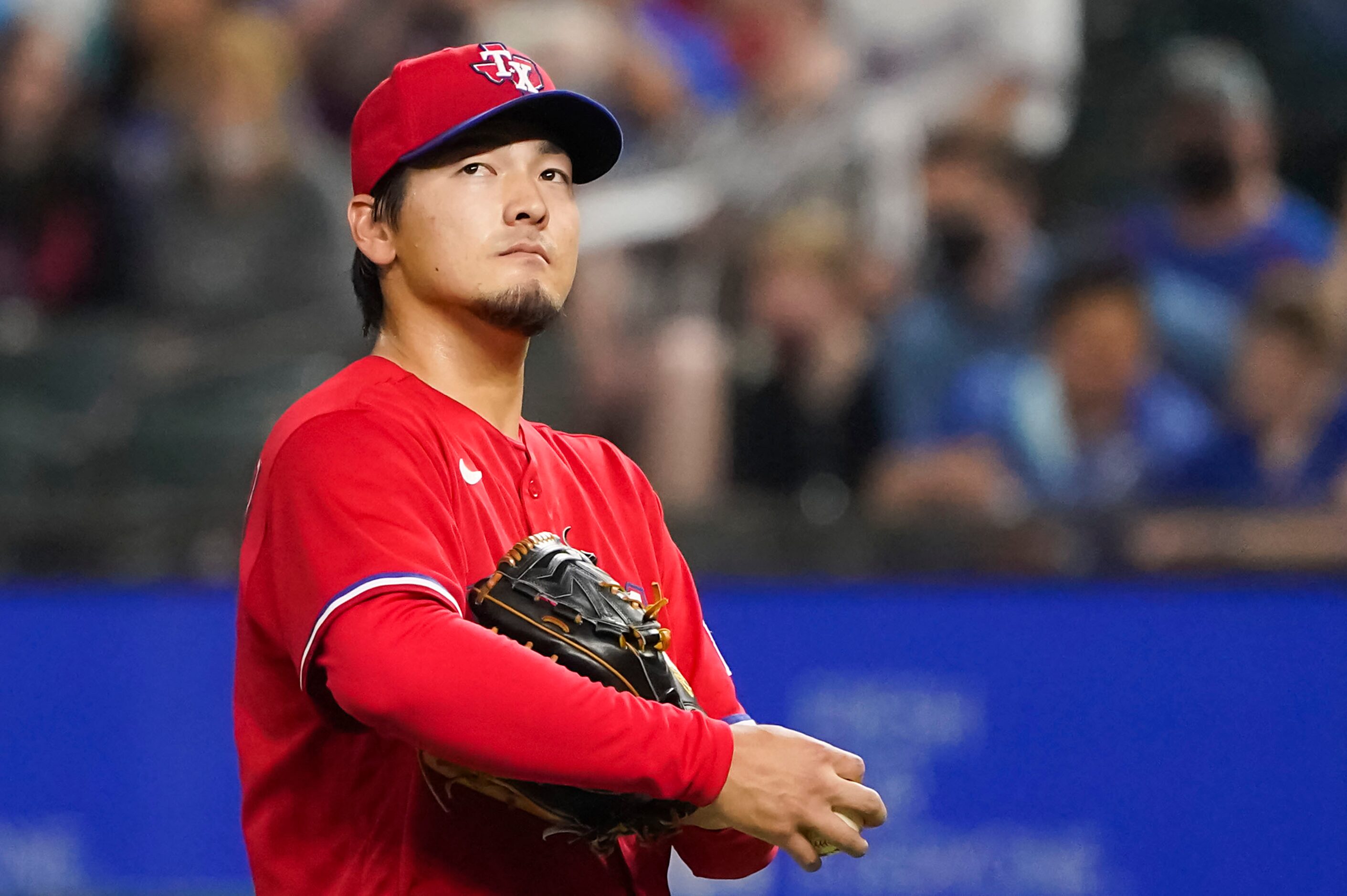 Texas Rangers pitcher Kohei Arihara reacts after giving up a run on a double by San Diego...