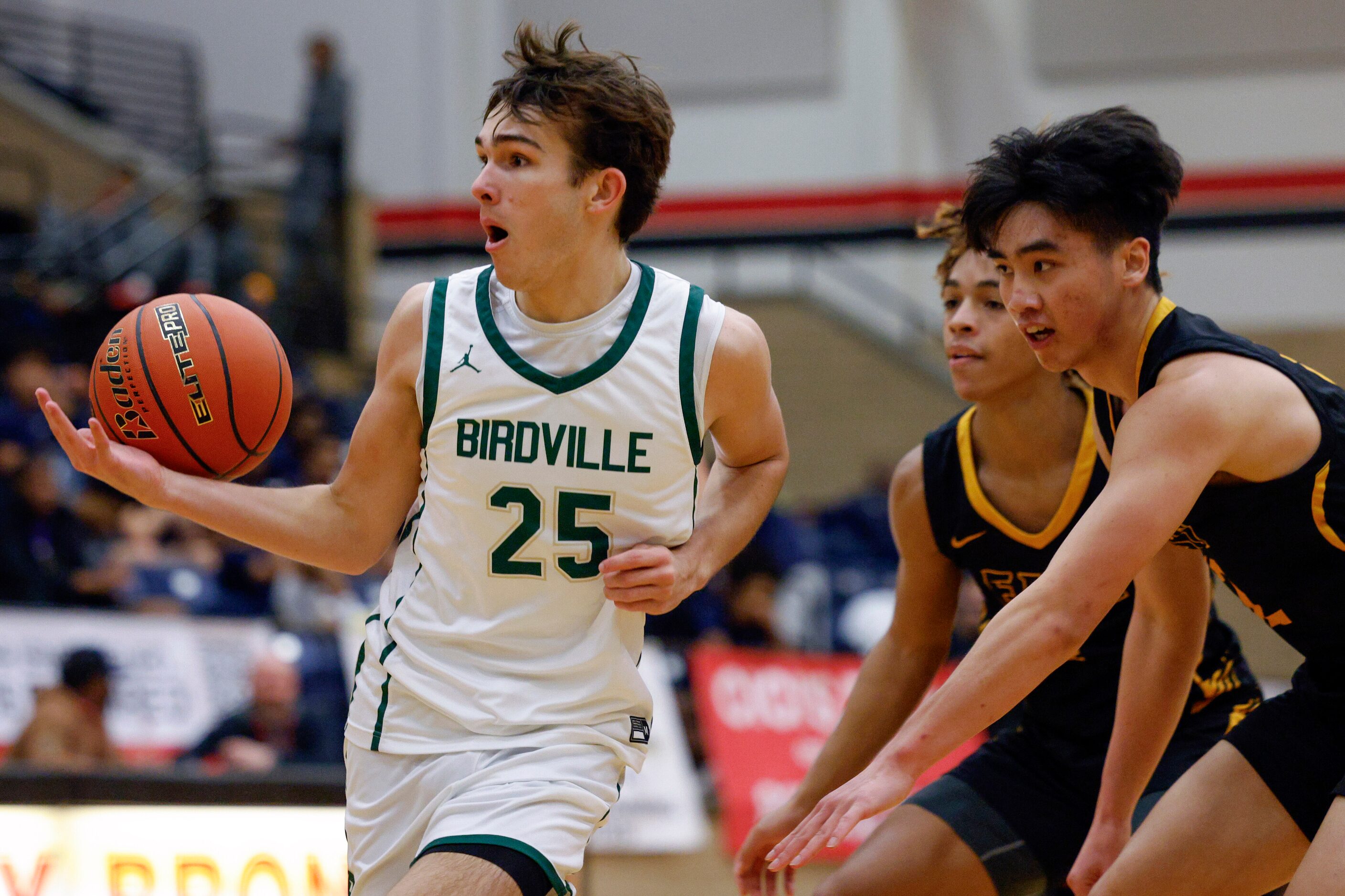 Birdville guard Niko Lucero (25) loses control of the ball as he drives against Plano East...