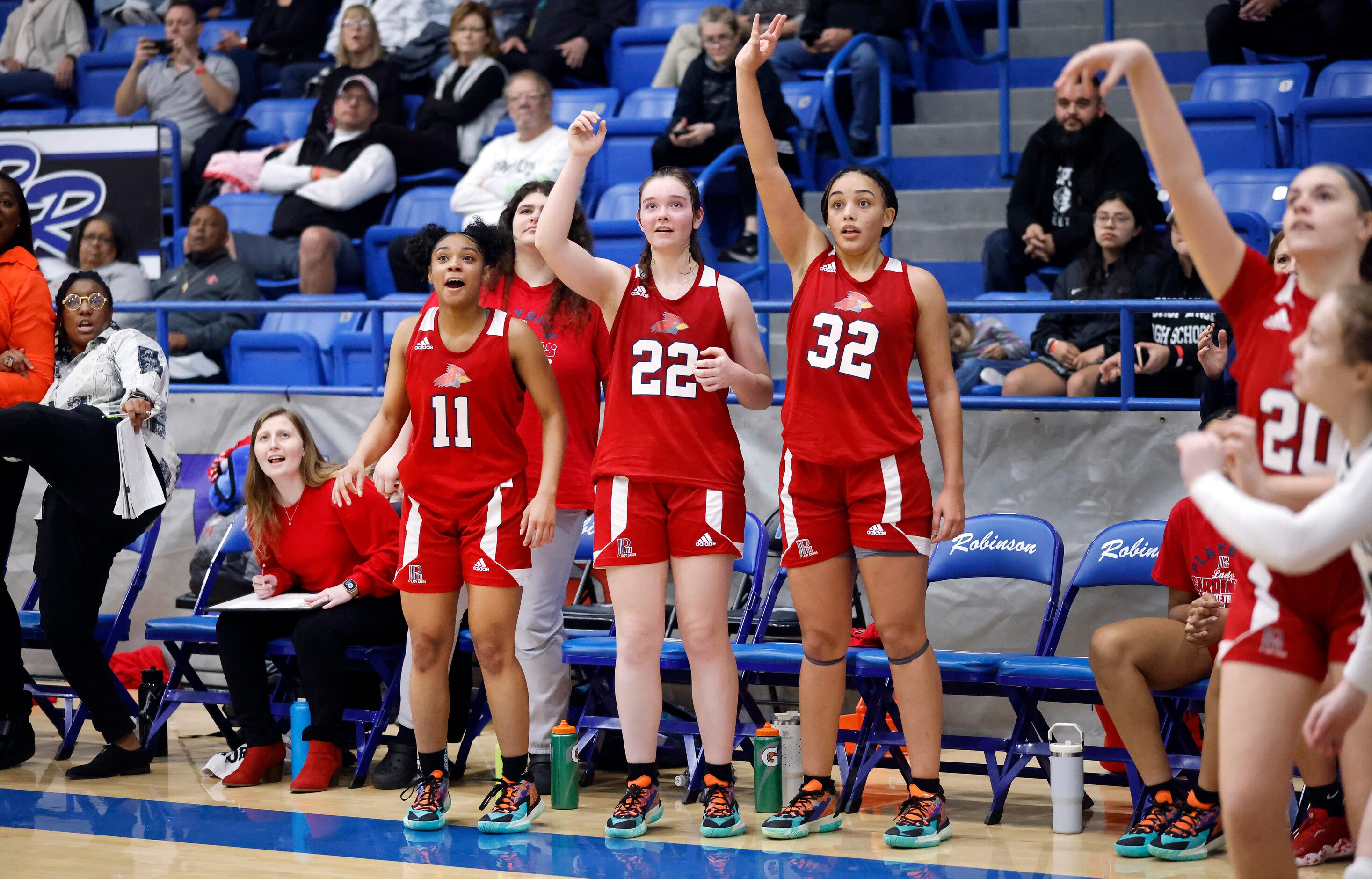 John Paul II players Lydia Cooke-Wiggins (11), Clara Paynter (22), Allysia McDaniel (32) and...